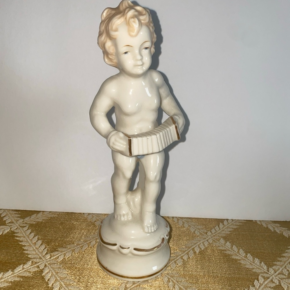 Vintage Porcelain boy playing accordion made in‎ Japan